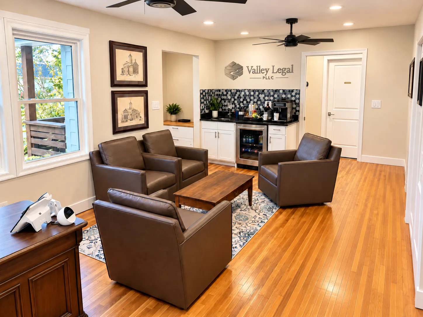 Valley Legal's reception area, with seating around a low table and the firm's logo on the wall